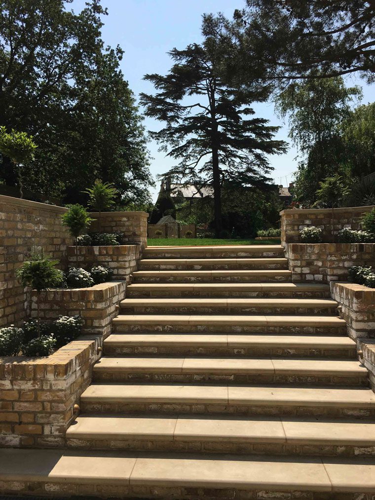 top end outdoor staircase and stone steps with planting eith side